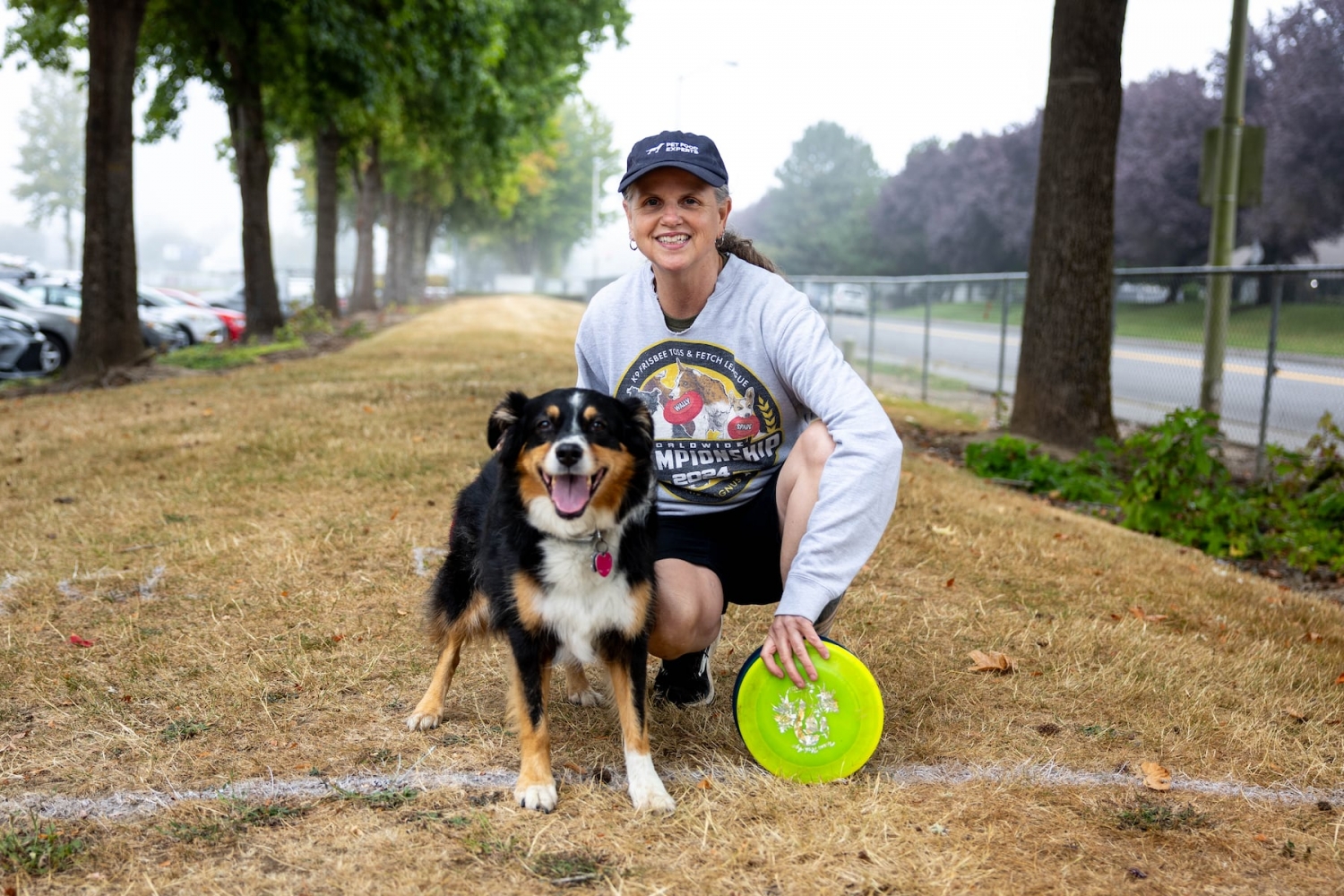 Handlers and dogs play frisbee in Vancouver as part of an international competition