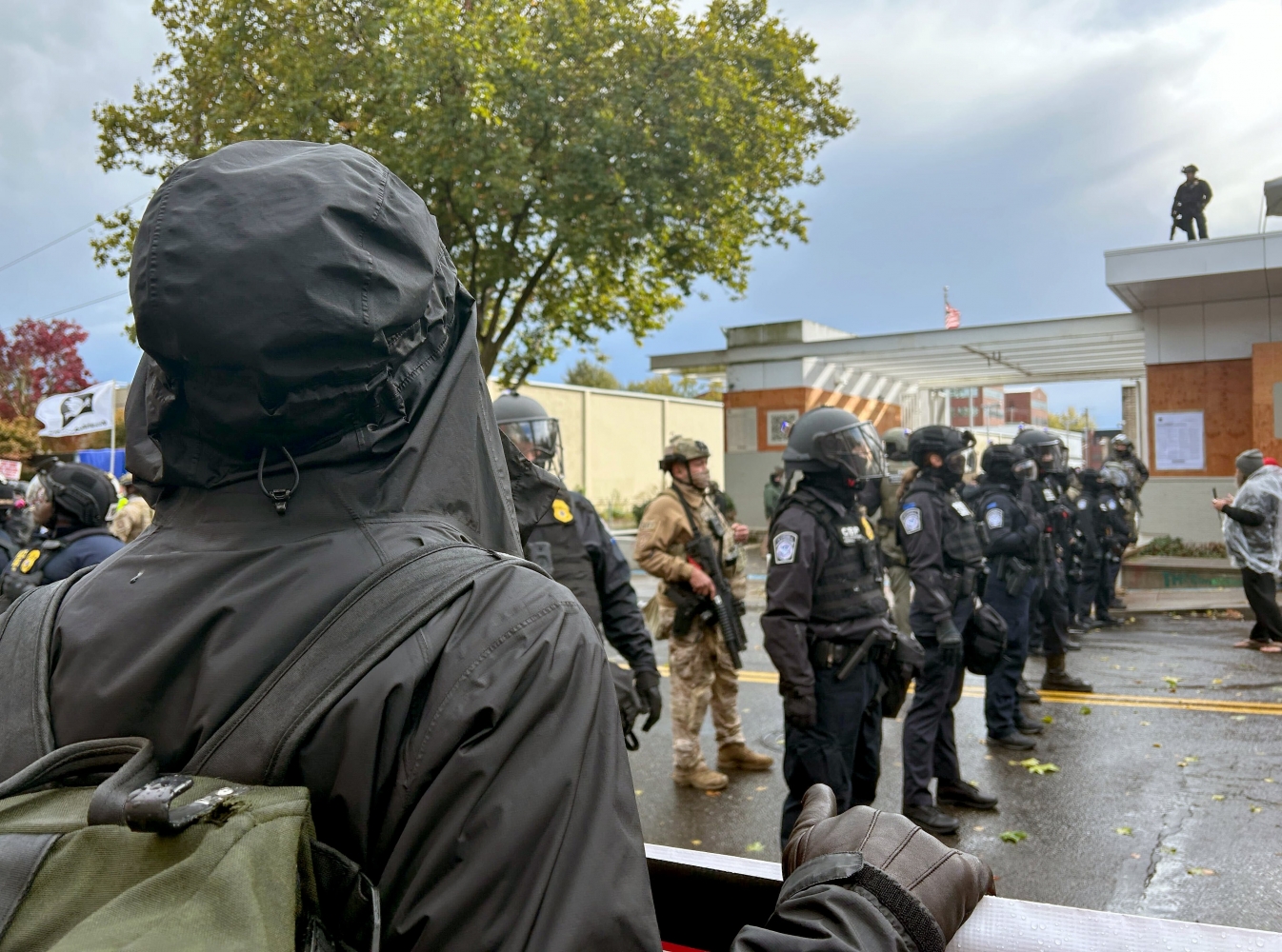 Small crowd rallies in the rain at Portland ICE facility as federal deployment remains on hold